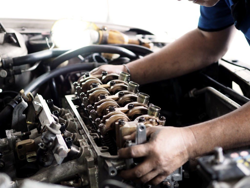 Diesel mechanics replacing or repairing defective parts.